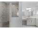 Luxurious bathroom with marble shower, dual sinks, and plenty of counter space at 1796 Zientara Loop, The Villages, FL 32163