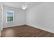 Bedroom with a window offering natural light, wood flooring, and a ceiling fan, creating a comfortable space at 1796 Zientara Loop, The Villages, FL 32163