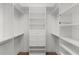 Well-organized walk-in closet with shelving, drawers, and hanging rods, maximizing storage space at 1796 Zientara Loop, The Villages, FL 32163