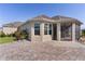 Back exterior featuring a screened-in lanai, and a paver patio at 1796 Zientara Loop, The Villages, FL 32163