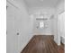 Bright foyer with wood flooring, glass front door, chandelier, and arched doorway offering modern elegance at 1796 Zientara Loop, The Villages, FL 32163