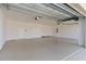 Spacious and well-lit three-car garage featuring epoxy flooring and ample storage space and a high ceiling at 1796 Zientara Loop, The Villages, FL 32163
