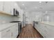 Modern kitchen features stainless steel appliances, gas range, sleek countertops, and bright white cabinetry at 1796 Zientara Loop, The Villages, FL 32163