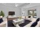 Bright living room featuring hardwood floors, a cozy seating area, and sliding glass doors to backyard at 1796 Zientara Loop, The Villages, FL 32163