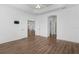Open-concept living space showcases wood floors, decorative ceilings, and seamlessly connects to other rooms at 1796 Zientara Loop, The Villages, FL 32163