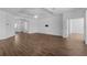 Spacious and bright living area with hardwood floors, white walls and easy access to other rooms at 1796 Zientara Loop, The Villages, FL 32163