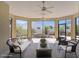 Staged covered patio with seating area, serene view, and ceiling fans at 1796 Zientara Loop, The Villages, FL 32163