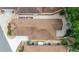 Aerial view of a home showcasing a well-maintained roof, patio, and landscaped backyard with a fountain and outdoor seating at 1814 Marquez Loop, The Villages, FL 32159