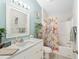 Well-lit bathroom with a shower-tub combination, a floral shower curtain, and modern fixtures at 1814 Marquez Loop, The Villages, FL 32159