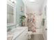Clean bathroom with a vanity, floral shower curtain, and decorative accents at 1814 Marquez Loop, The Villages, FL 32159