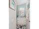 Charming bathroom with white vanity, coastal theme, and a decorative seashell rug at 1814 Marquez Loop, The Villages, FL 32159