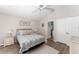 Bedroom showcasing wood floors, a ceiling fan, and ensuite bathroom access at 1814 Marquez Loop, The Villages, FL 32159
