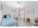 Cozy bedroom with a twin bed, desk, and a large window offering natural light at 1814 Marquez Loop, The Villages, FL 32159