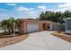 Charming single-story home featuring a well-maintained lawn, attached garage, and inviting curb appeal at 1814 Marquez Loop, The Villages, FL 32159