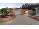 Charming single-story home featuring a well-maintained lawn, attached garage, and inviting curb appeal at 1814 Marquez Loop, The Villages, FL 32159
