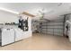 Spacious garage area with washer, dryer, shelving and ample storage space at 1814 Marquez Loop, The Villages, FL 32159