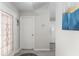 Bright hallway showcasing updated flooring and views of the adjacent kitchen and entry door at 1814 Marquez Loop, The Villages, FL 32159