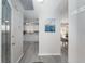 Bright hallway showcasing updated flooring and views of the adjacent kitchen and dining areas at 1814 Marquez Loop, The Villages, FL 32159