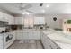 Well-lit kitchen featuring white cabinets, marble countertops, and modern appliances at 1814 Marquez Loop, The Villages, FL 32159