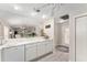 Bright kitchen featuring white cabinets, marble countertops, and seamless flow into the entry door at 1814 Marquez Loop, The Villages, FL 32159