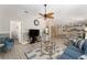 Open-concept living area with a blue sofa, unique ceiling fan, and easy access to other rooms at 1814 Marquez Loop, The Villages, FL 32159