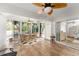 Enclosed patio with ample seating, tile floors, and view of the backyard at 1814 Marquez Loop, The Villages, FL 32159