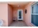 Inviting front porch featuring tiled flooring, decorative wall art, and a charming welcome mat at 1814 Marquez Loop, The Villages, FL 32159