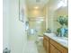 Bathroom showcasing a glass-enclosed shower, tile floors, and a stylish granite-top vanity at 1954 Ladyfish Ave, The Villages, FL 32162
