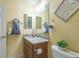 Bathroom featuring a granite countertop, vanity, and decorative towel arrangement at 1954 Ladyfish Ave, The Villages, FL 32162