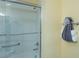 Bathroom showcasing a glass shower with an access bar and decorative towel arrangement at 1954 Ladyfish Ave, The Villages, FL 32162