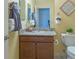 Bathroom showcasing a granite countertop vanity and decorative wall art at 1954 Ladyfish Ave, The Villages, FL 32162