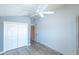 Bedroom featuring a closet, ceiling fan, neutral walls, and wood-look floors at 1954 Ladyfish Ave, The Villages, FL 32162