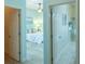 Bedroom with light blue walls, view of a closet, and view of the en-suite bathroom at 1954 Ladyfish Ave, The Villages, FL 32162