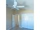 Bedroom features include light wood flooring, a ceiling fan, a walk-in closet and access to the ensuite bathroom at 1954 Ladyfish Ave, The Villages, FL 32162