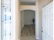 Inviting entryway features an arched doorway and wood-look flooring at 1954 Ladyfish Ave, The Villages, FL 32162