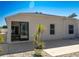 Exterior view of the home showcases a patio area, sliding glass doors, and low maintenance landscaping at 1954 Ladyfish Ave, The Villages, FL 32162
