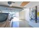 This garage features speckled epoxy floors, a vehicle, and a workspace with built-in storage and mechanics at 1954 Ladyfish Ave, The Villages, FL 32162