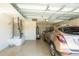 Spacious garage features speckled epoxy floors, a vehicle, air conditioning unit, and a workspace at 1954 Ladyfish Ave, The Villages, FL 32162