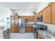 Well-equipped kitchen with stainless steel appliances and granite countertops at 1954 Ladyfish Ave, The Villages, FL 32162