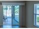 A cozy room seen through sliding glass doors with views of the green backyard and nearby fence at 1954 Ladyfish Ave, The Villages, FL 32162
