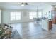 Spacious living room with vaulted ceilings, lots of natural light and wood-look floors at 1954 Ladyfish Ave, The Villages, FL 32162