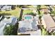 Aerial view of a home with a screened-in pool, fenced backyard, and well-maintained landscaping at 2037 Lakeshore Dr, Mount Dora, FL 32757