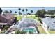 An aerial view of a property that features a screened pool, lush landscaping, and access to waterfront views at 2037 Lakeshore Dr, Mount Dora, FL 32757