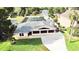 Expansive home features a screened-in pool, lush landscaping, and a long driveway for easy parking at 2037 Lakeshore Dr, Mount Dora, FL 32757