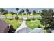 An aerial view showcasing the long driveway, manicured lawn, and the serene waterfront setting of the property at 2037 Lakeshore Dr, Mount Dora, FL 32757