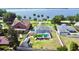 Expansive backyard featuring a screened pool, lush greenery, and a charming shed, complemented by stunning water views at 2037 Lakeshore Dr, Mount Dora, FL 32757