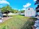 Spacious backyard with a shed and lush lawn is perfect for outdoor activities and relaxation at 2037 Lakeshore Dr, Mount Dora, FL 32757