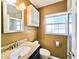 Bathroom with granite countertop, basin sink, built-in cabinets, and framed mirror at 2037 Lakeshore Dr, Mount Dora, FL 32757