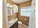 Cozy bathroom with granite countertop, decorative mirror, and tiled shower at 2037 Lakeshore Dr, Mount Dora, FL 32757