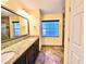 Bright bathroom with granite countertops, dual sinks, decorative tile floor, and large window at 2037 Lakeshore Dr, Mount Dora, FL 32757
